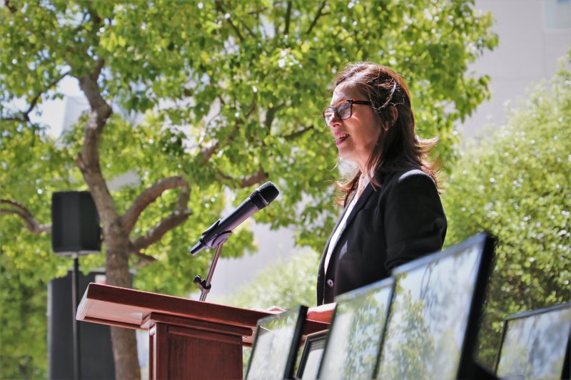 Side view of Dorna giving speech at podium at the 2022 Public Service Program Award Luncheon