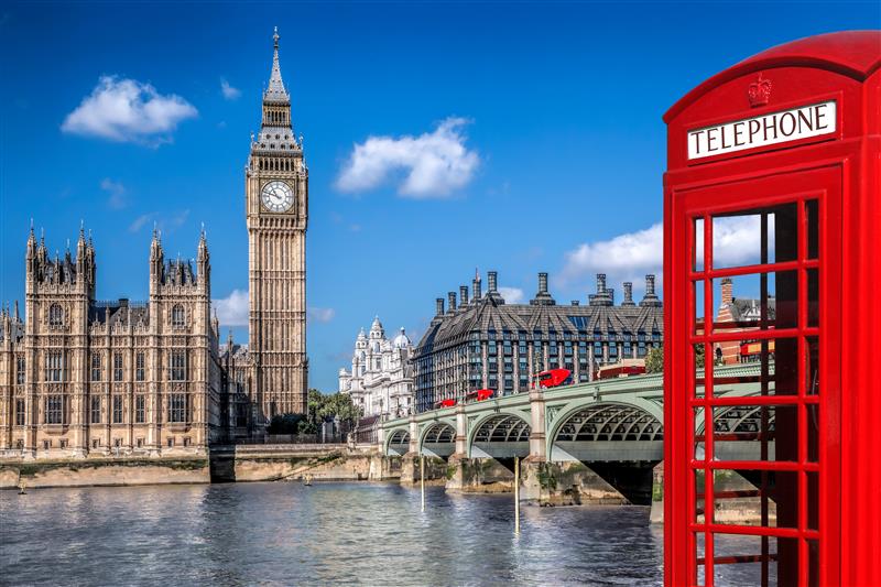 Red telephone booth in foreground with London Big Ben tower in the background