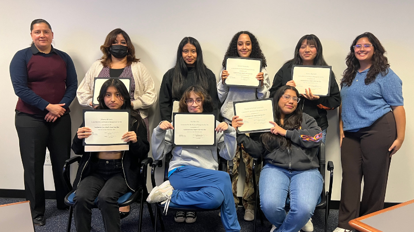 New Village Girls Academy Class with their certificates at their culminating class at Southwestern. 