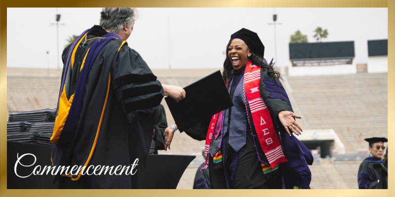 Commencement Banner featuring student in cap and gown smiling as she goes in for a hug with the Dean