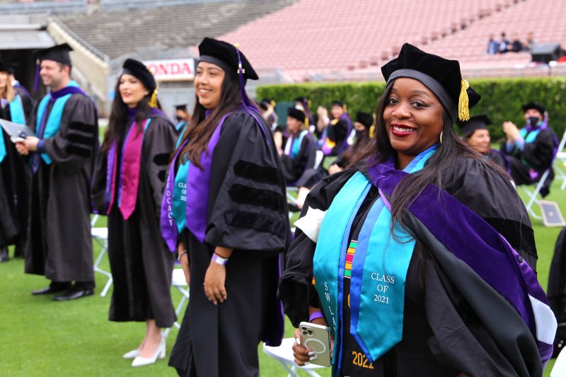 Image - Southwestern 2021 Grads standing socially distanced apart on the Rose Bowl field smiling at camera