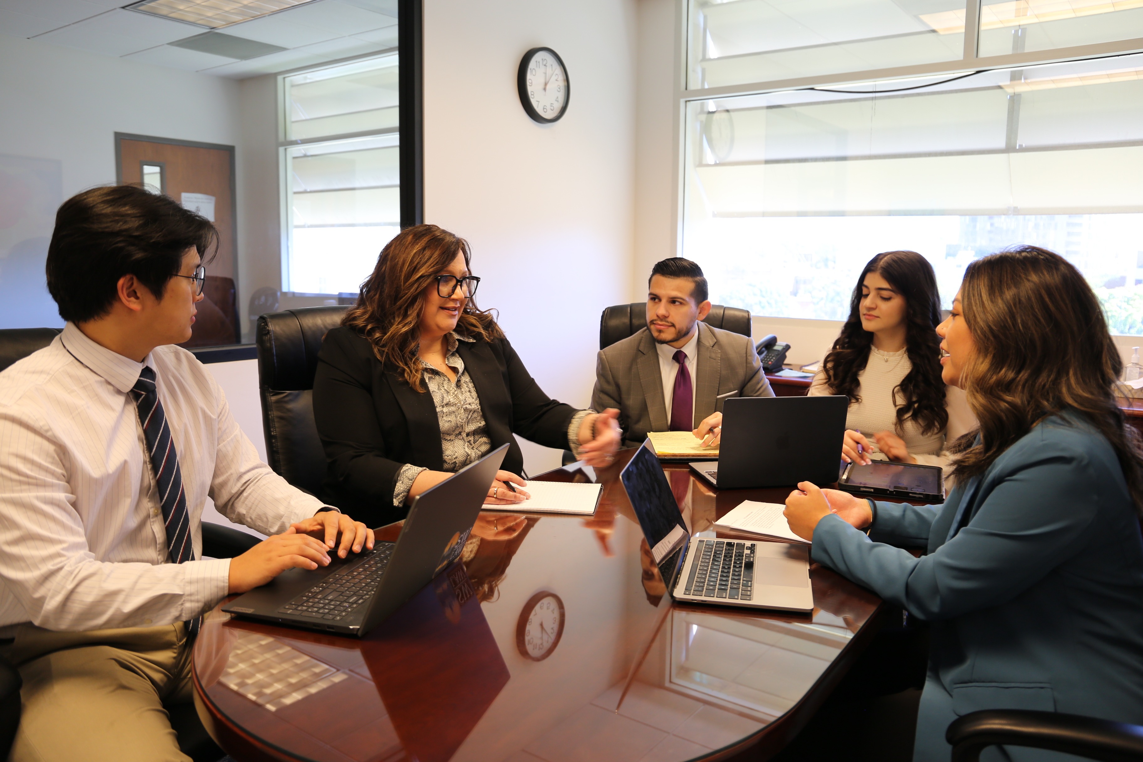Professor Fee with students discussing around the table