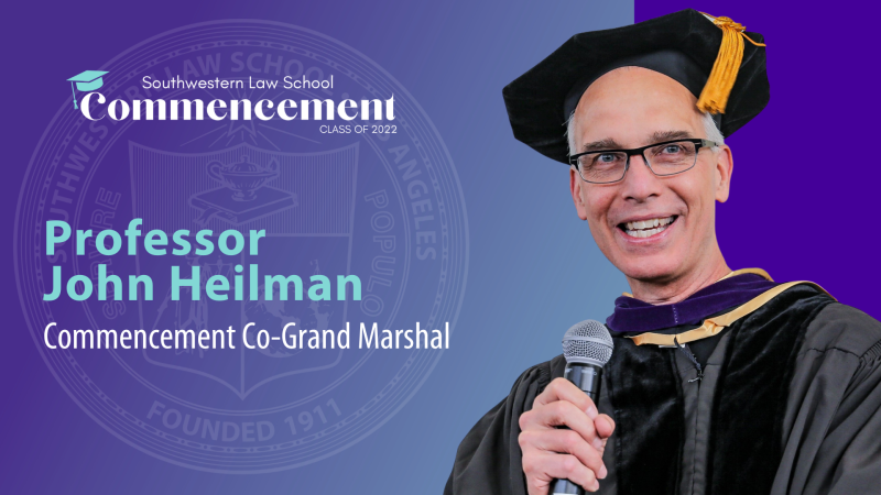 Commencement Co-Grand Marshal Slide depicting Prof. John Heilman holding a microphone in cap and gown with the SWLAW Commencement Class of 2022 Logo at the top and text "Professor John Heilman Commencement Co-Grand Marshall" to the left of picture and SWLAW seal in the background
