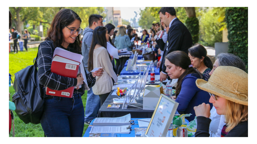 Students meeting representatives at booths at the Public Interest Public Service Employer Fair 